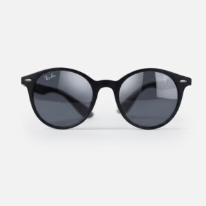 Matte black round sunglasses featuring dark grey lenses and a Scuderia Ferrari shield logo.