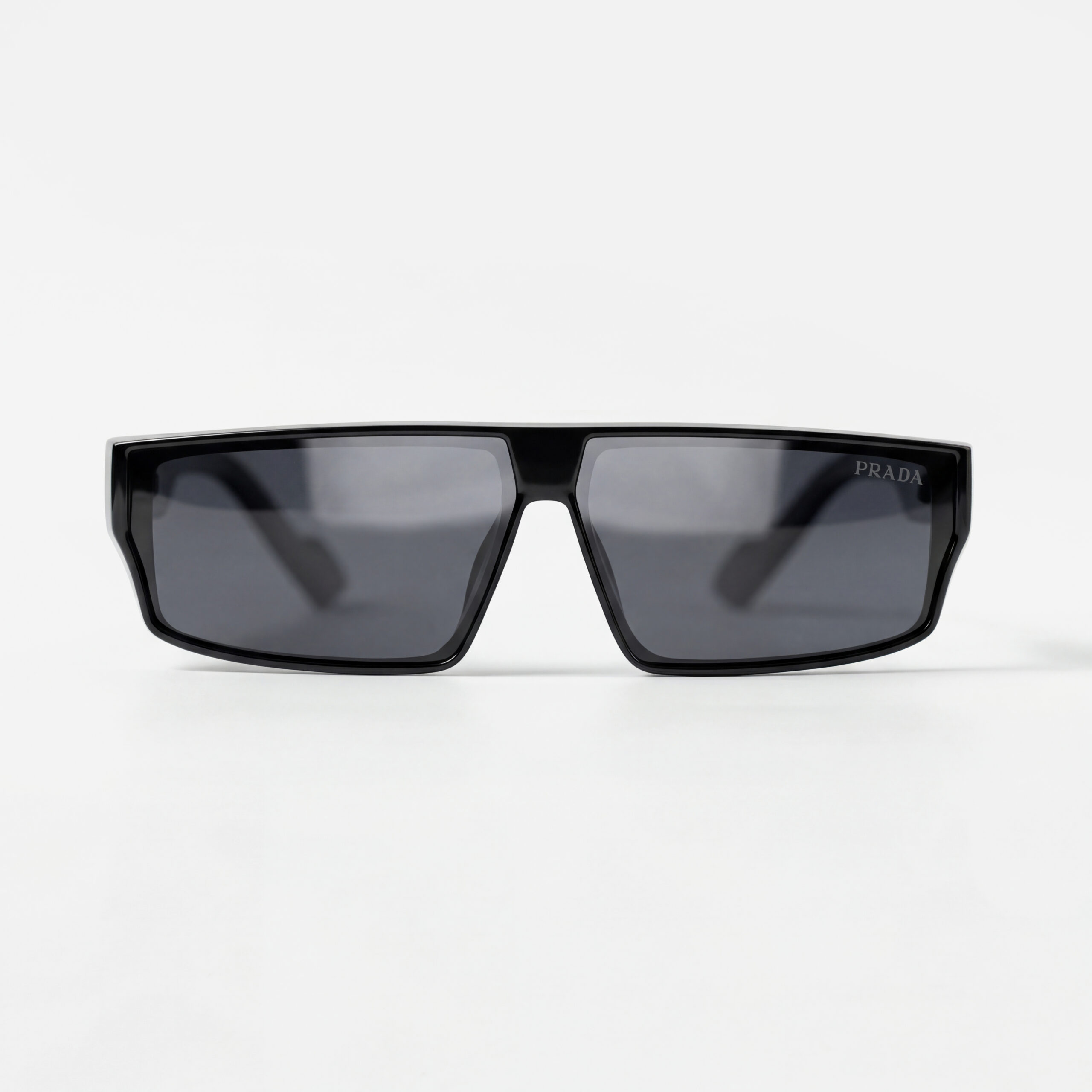 Glossy black rectangular sunglasses with dark lenses and a modern flat-top frame design.